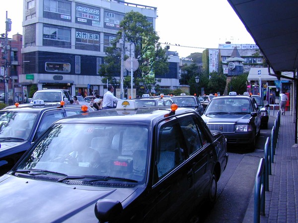 Many taxi cabs wait